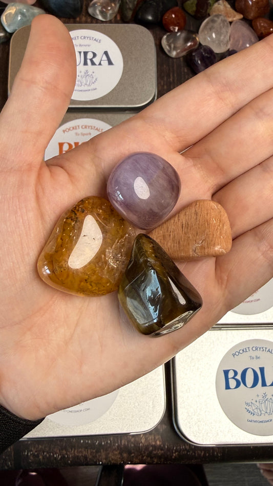 Golden Healer, Peach Moonstone, Tigers Eye, and Flourite in palm of hand