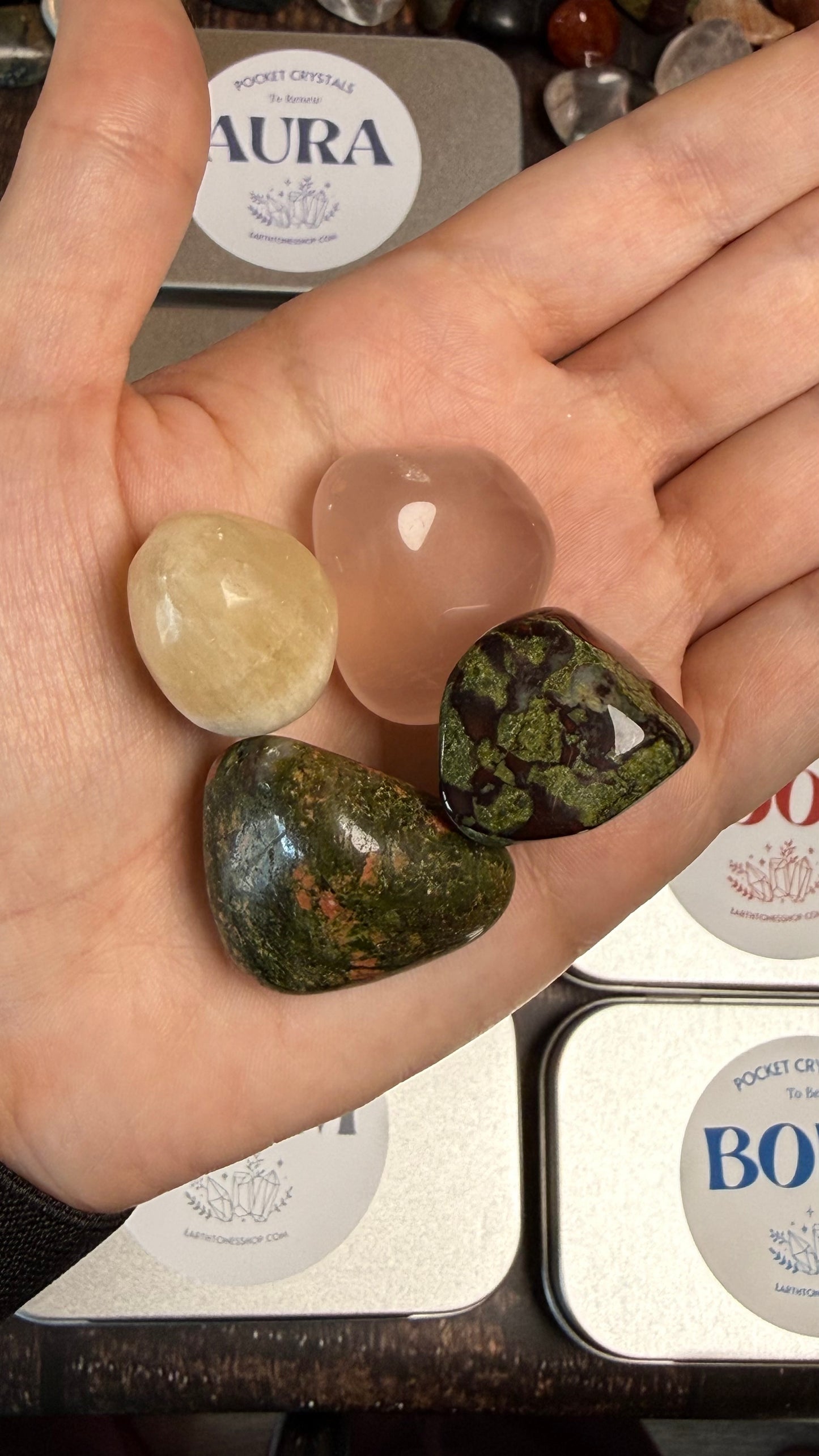 Dragon Bloodstone, Honey Calcite, Unakite and Rose quartz iin palm of hand