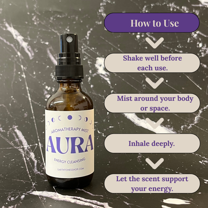 Aromatherapy mist bottle labeled 'Aura' with usage instructions on a textured background