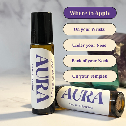 Aura essential oil roll-on bottles with application instructions on a neutral background