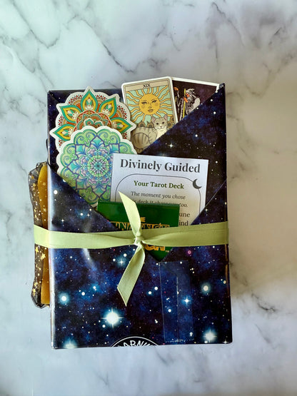 Tarot deck packaging with cards peeking out on a marble surface