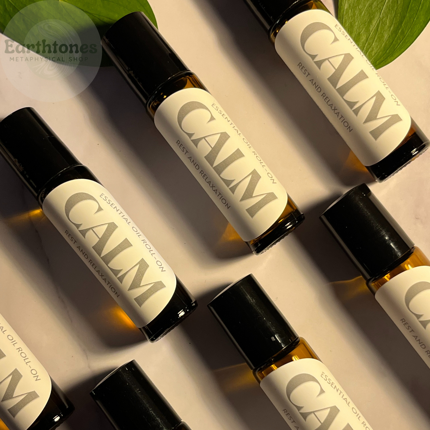 Roll-on bottles labeled 'CALM' on a neutral background