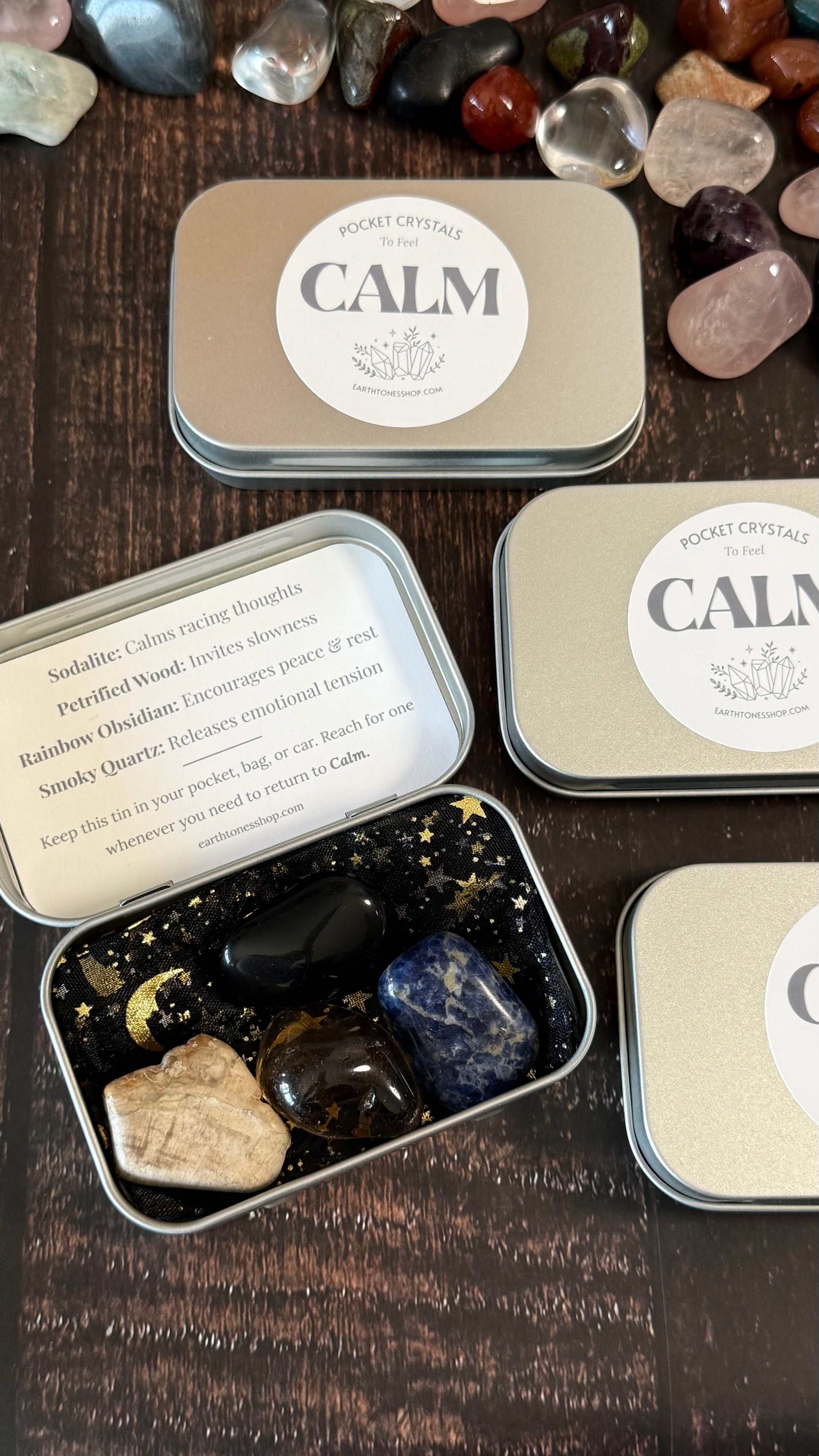 Sodalite, Petrified Wood, Rainbow obsidian, smoky quartz in tin on faux wood background 