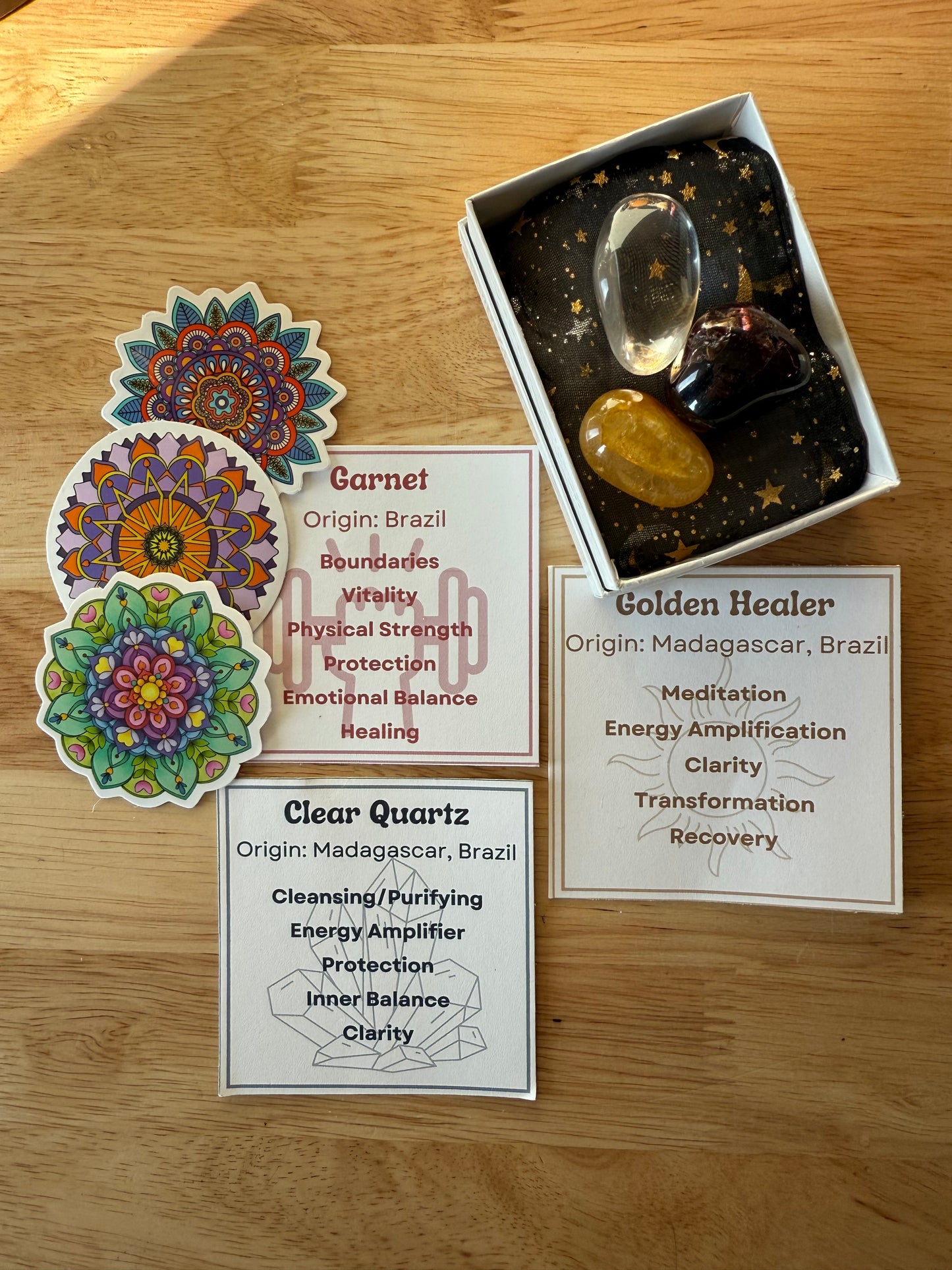 Crystal set with cards and decorative stickers on a wooden surface