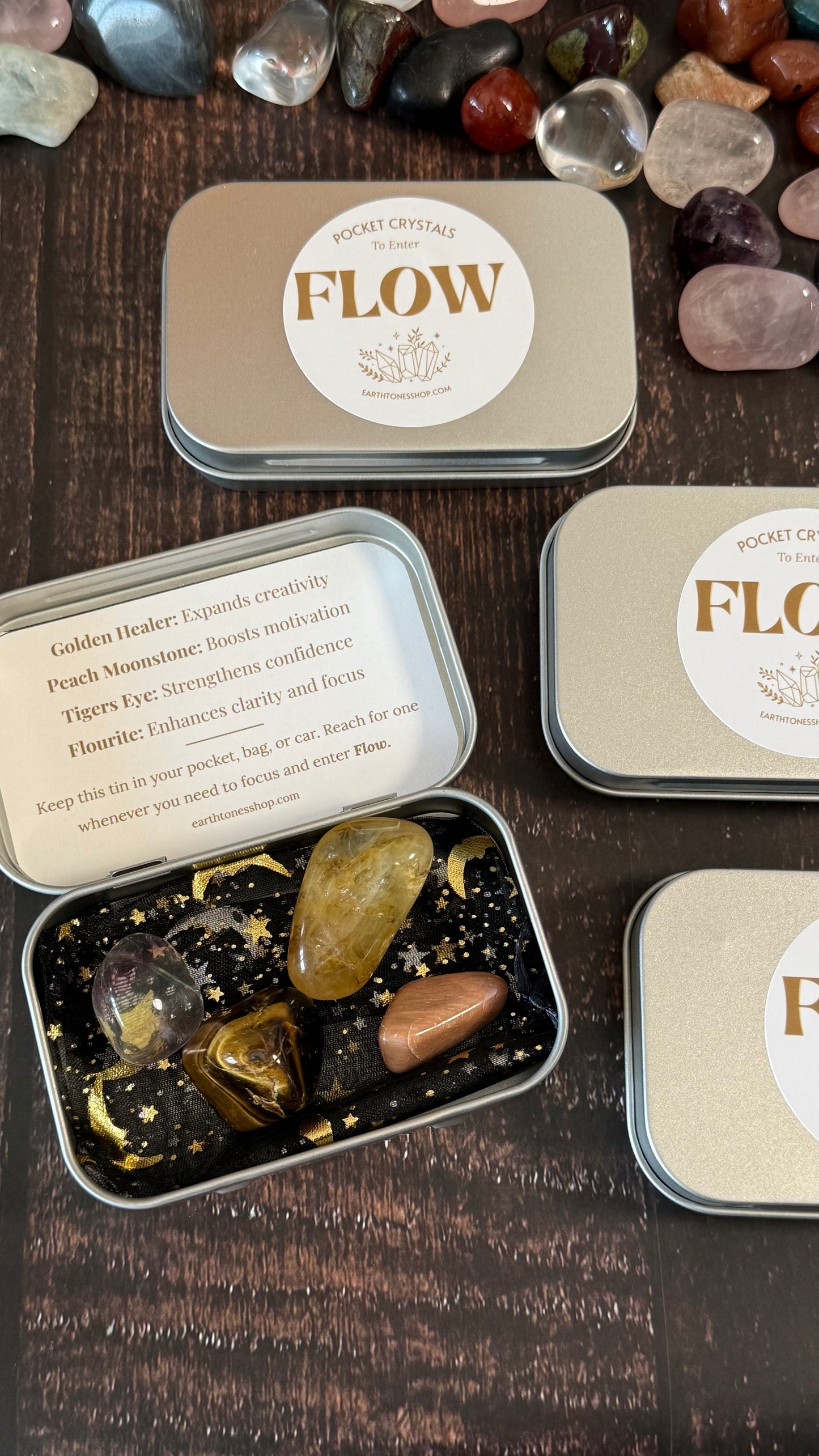 Golden Healer, Peach Moonstone, Tigers Eye, and Flourite  in tin on faux wood background 