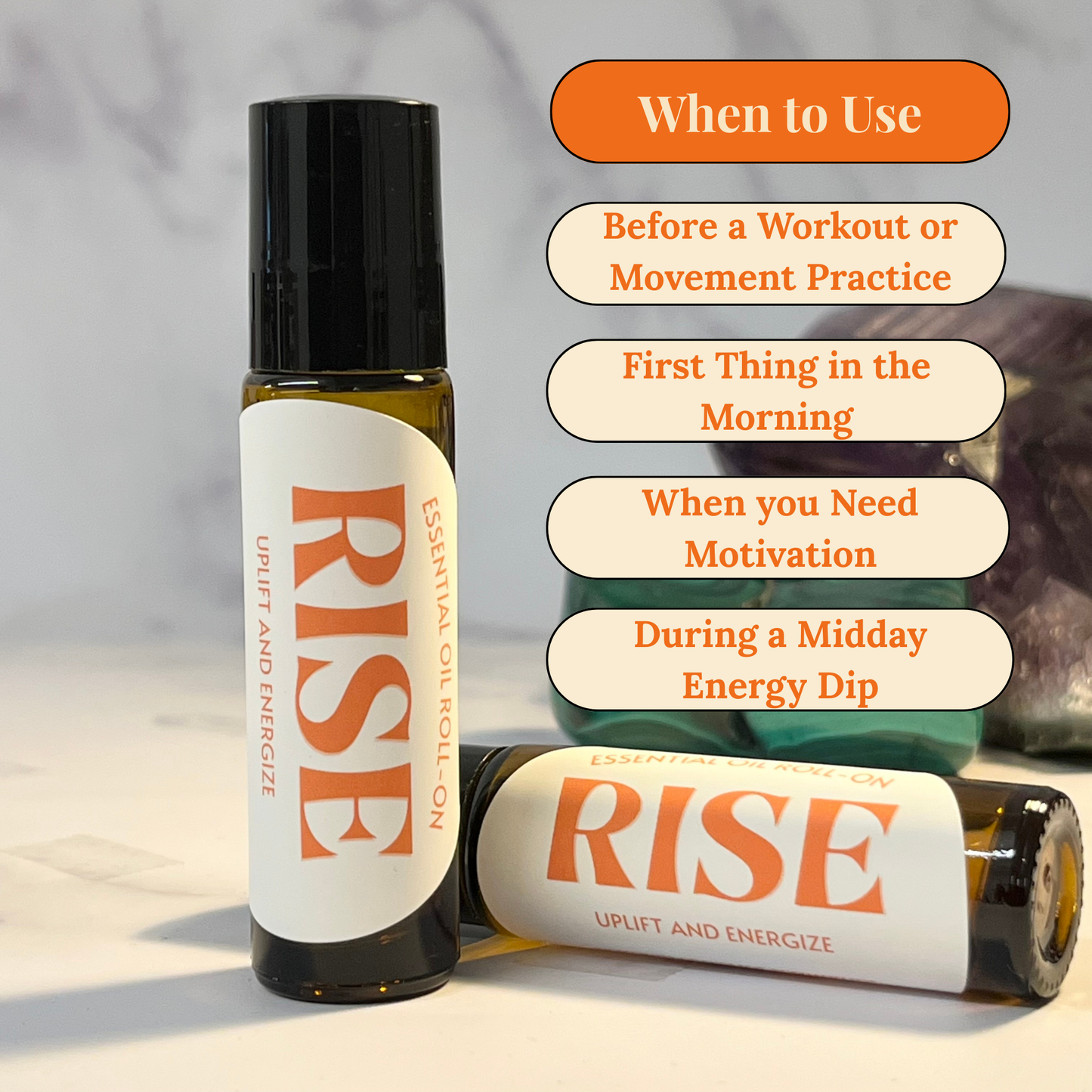 Two bottles of 'RISE' essential oil roll on with usage tips on a light background