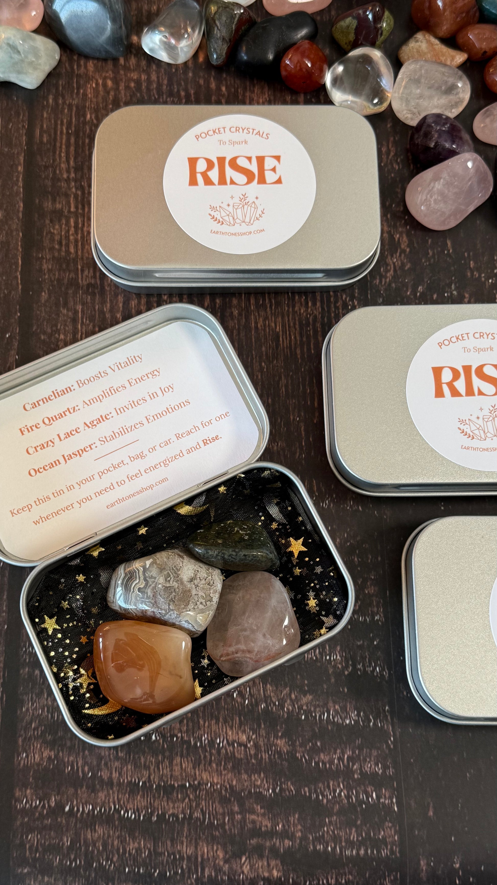 Carnelian, Fire Quartz, Crazy Lace Agate and Ocean Jasper in tin on faux wood background 