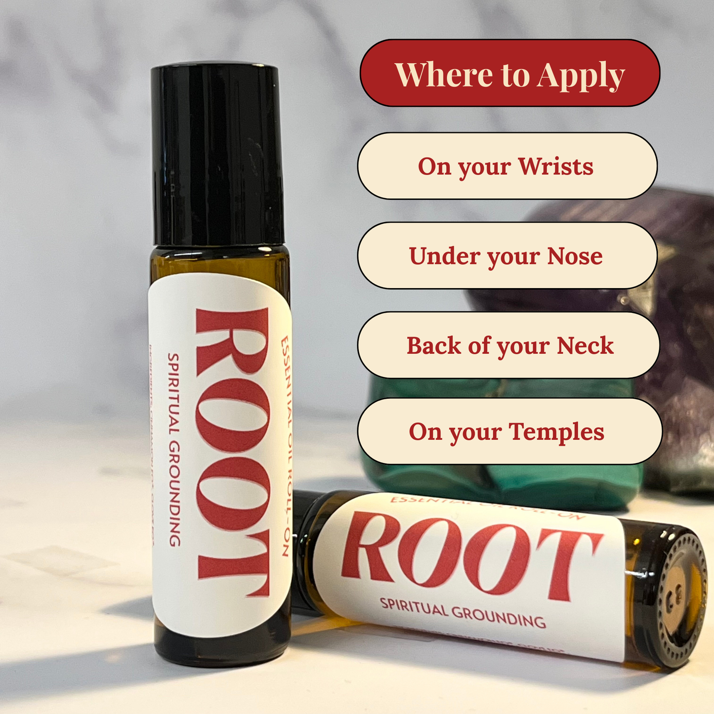 Two bottles of 'ROOT' spiritual grounding essential oil with application instructions on a neutral background.
