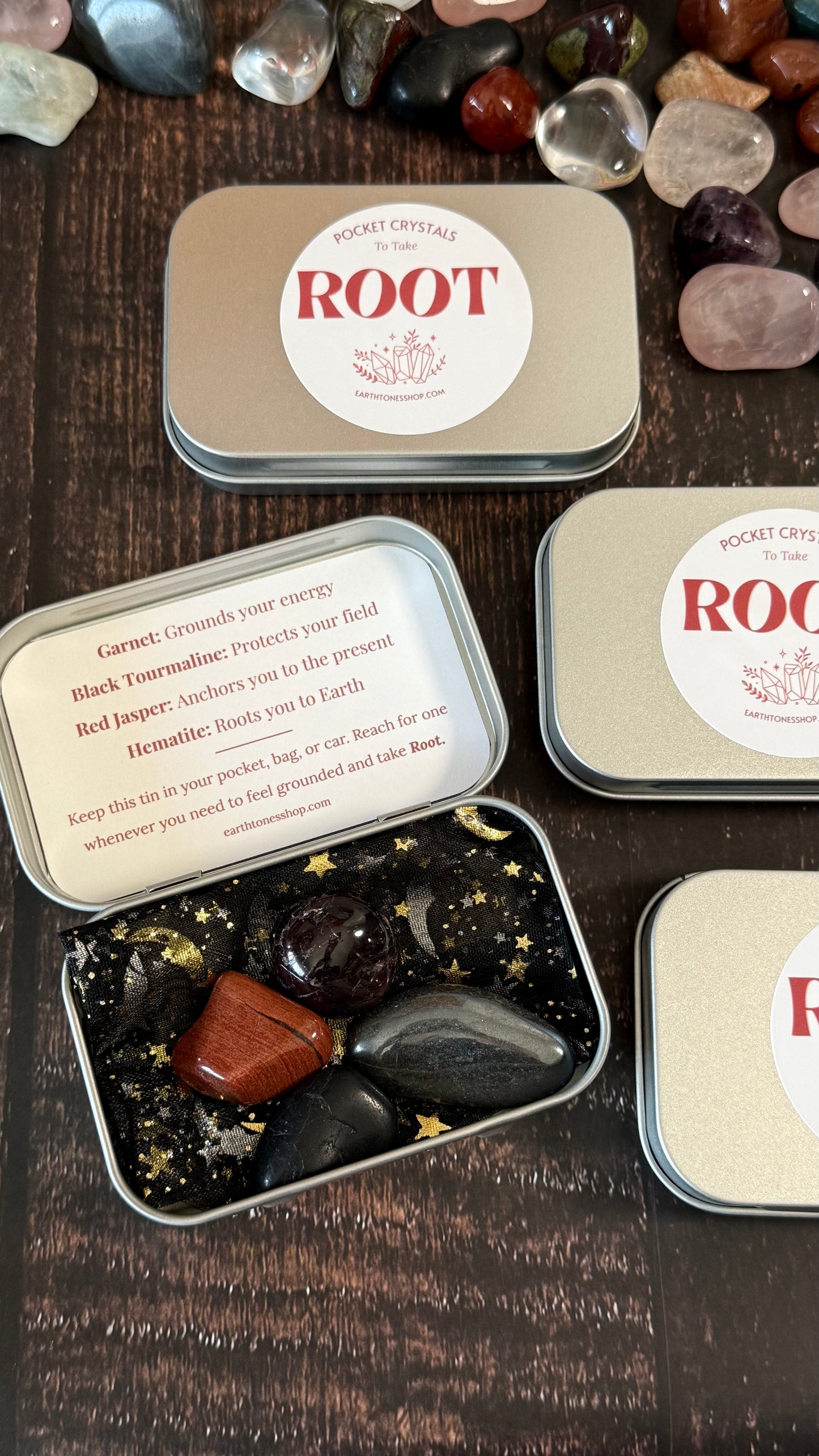 Garnet, Black tourmaline, Red Jasper & Hematite in tin on faux wood background 