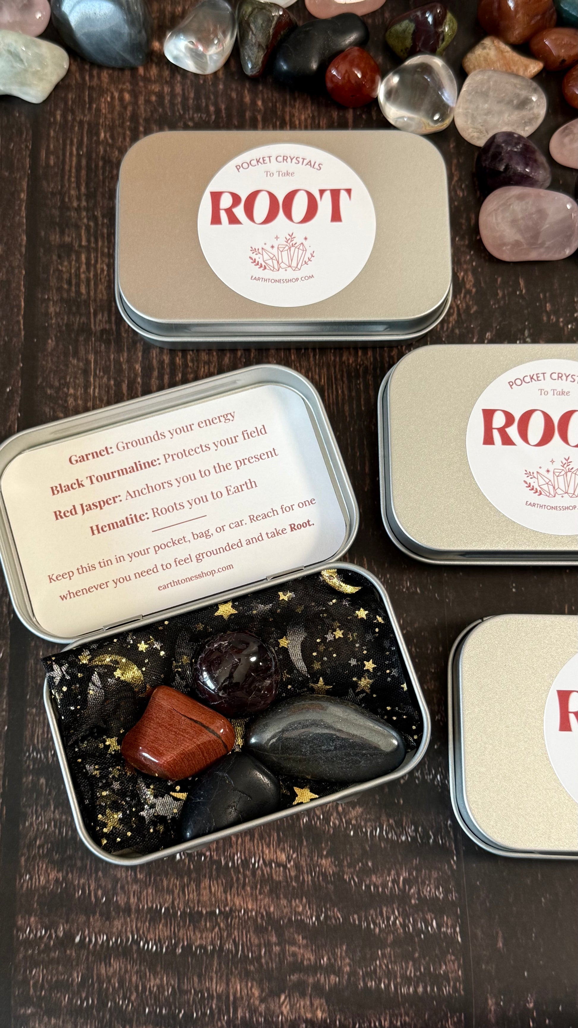 Garnet, Black tourmaline, Red Jasper & Hematite in tin on faux wood background 